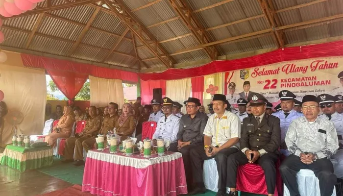 Pj Bupati Bolmut Hadiri Upacara HUT Ke-22 Kecamatan Pinogaluman